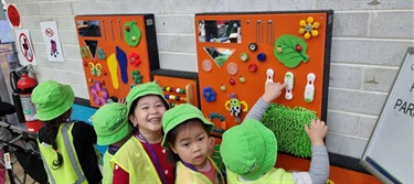 Children interacting with sensory boards