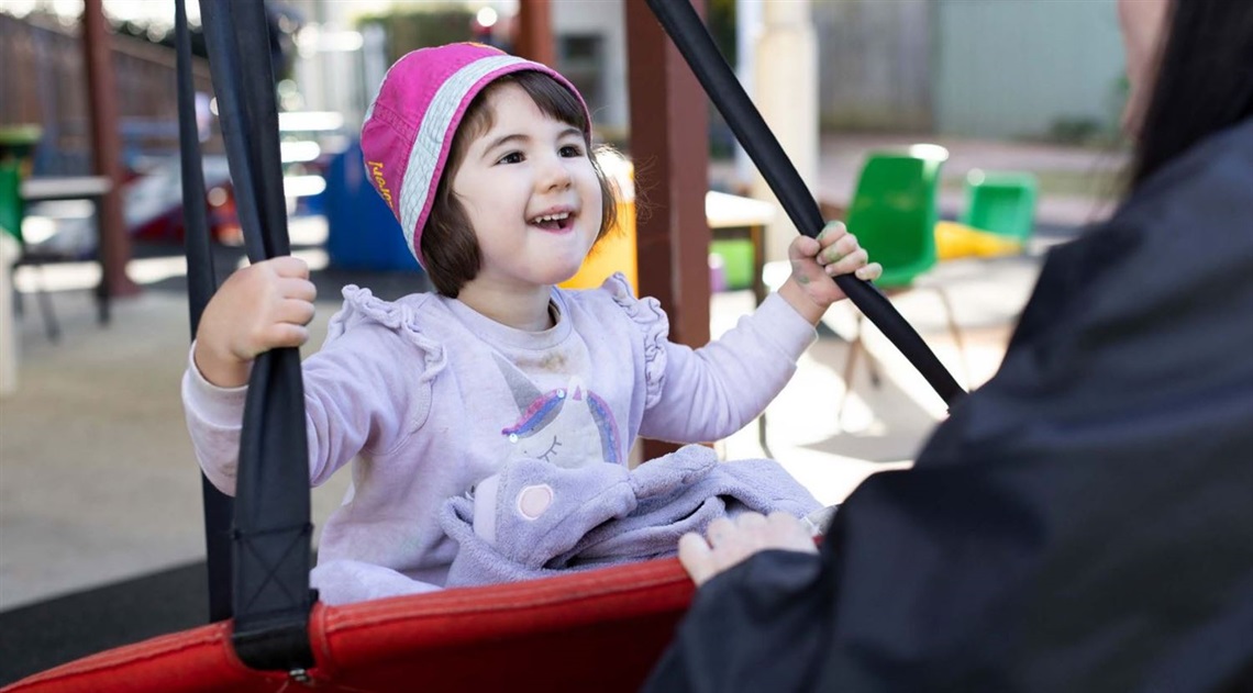 Young girl on large swing