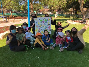 Cabramatta Early learning centre students with a thank you sign for the new playground