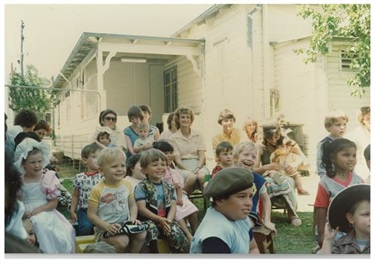 Young children sitting on benches at playgroup session in 1980s