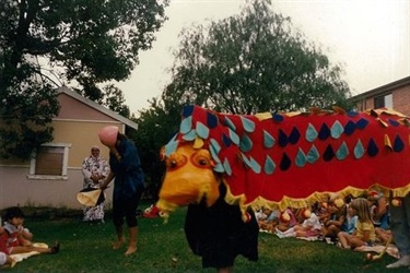 Young children watching lion dancing puppet performance for Chinese New Year