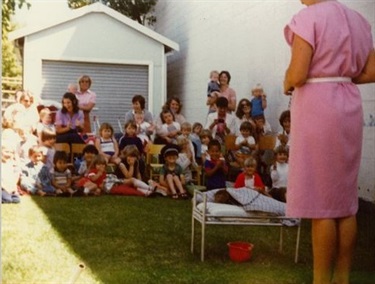 Nurse talking about health and hygiene to group of young children