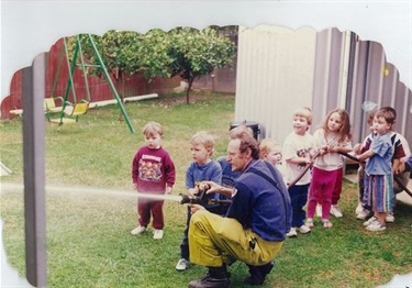Local Fairfield City Council Fire Brigade demonstrating fire hose to young children during Fire Safety Week incursion