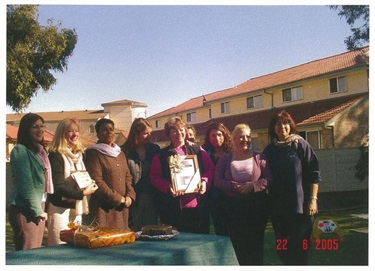 Educators smiling and posing with framed certificates at Farewell Ceremony