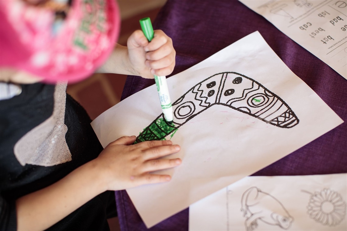 Child from Wakeley Early Learning Centre colouring in a picture of a boomerang